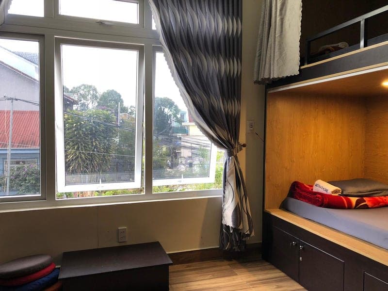 Wooden capsule bunks with privacy curtains in the Mooka's Home dorm