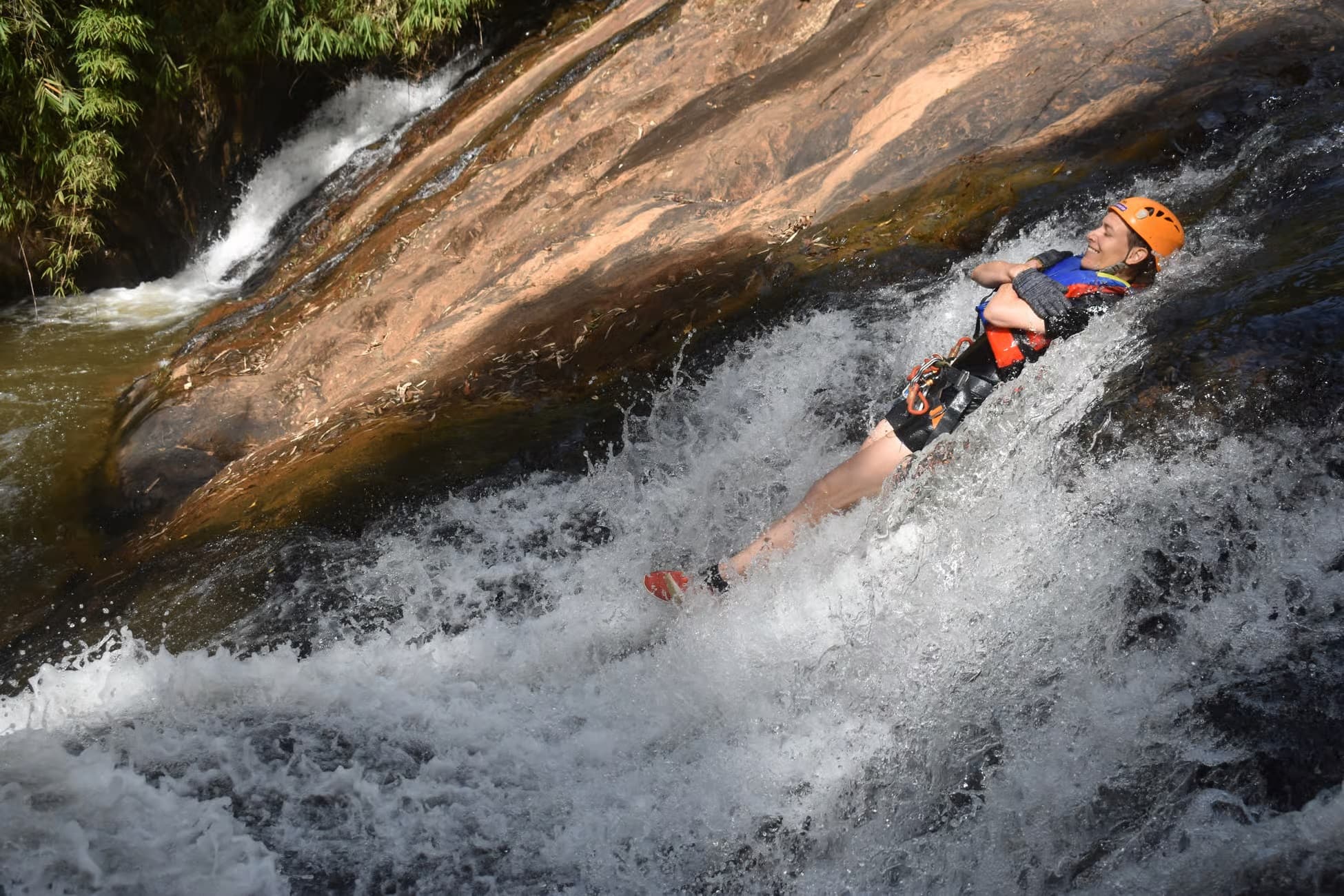 Abseiling down a waterfall on the Datanla canyoning tour in Da Lat